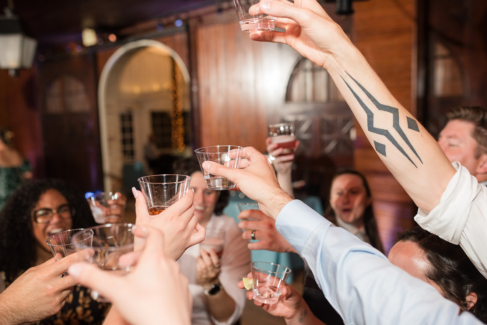 Katie + Rachel's guests cheers-ing their drinks.